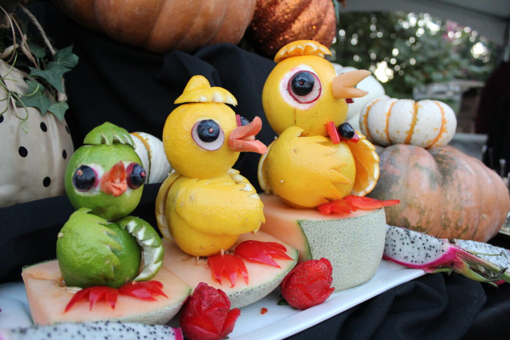 three duckies made out of fruit with googly eyes