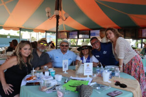 VIP-Table-1500 Friends around a table at the Taste of Arcadia VIP Area posing for a picture.