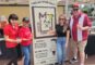 a group of four people standing by a banner reading Max's Mexican Cuisine