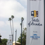 a large white banner with the Taste of Arcadia logo on it