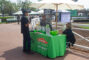 a group of people gathered at a booth for ServPro set with a green cloth