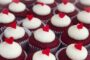 red velvet cupcakes with white icing and heart shaped decorations from Sweet Nothings