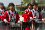 a group of male drummers in the red and white uniform of the Arcadia high school band