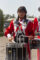 a female drummer with braids in the red and white uniform of the Arcadia high School band
