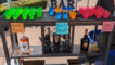 a bar set up with colorful cups and bottles of liquor with fun signs announcing the drink names
