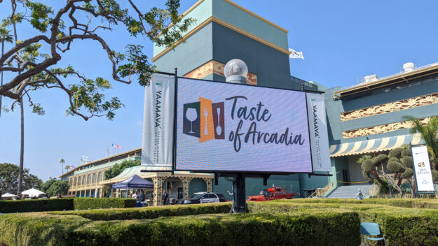 the Taste of Arcadia logo shown on a large LED screen
