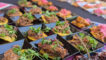 plates of beef on chips set out in rows