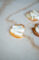 a piece of toast spread with white topping and drizzled with honey