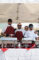 a group of four men standing behind a table set with chafers