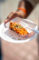 a plate of toasted bread crumbs topped with cheese and scallions