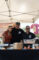 a woman and two men wearing Moffett's t-shirts standing behind a table set with chafers and pumpkins