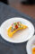 a plate of ceviche set in a chip on a white plate