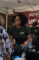 a woman in a black shirt with the Outback logo smiling at a customer