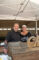 a woman in a Mt Lowe t shirt standing with a man in a black button up and both are smiling