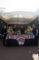 a group of people behind a booth set with colorful Mexican cloths