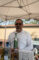 a man in a white button up shirt holding a bottle of tequila