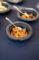 a delicious looking bowl of meat with a gold fork set in it