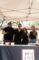 two women and two men all in black behind a table set with a table cloth with the Max's Logo on it
