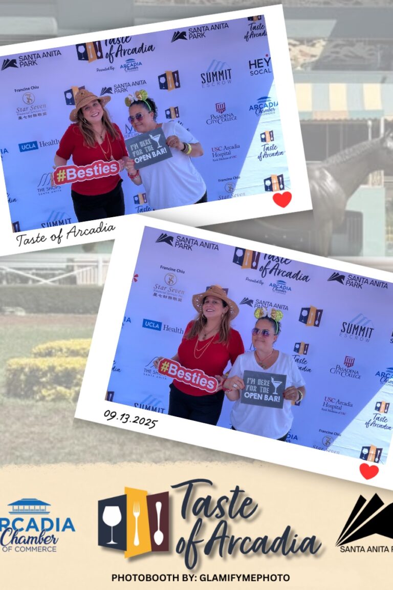a woman in a red shirt and straw hat holding a sign saying Bestie with a woman in a white t-shirt in a photo booth setting with a background showing the Taste of Arcadia logo