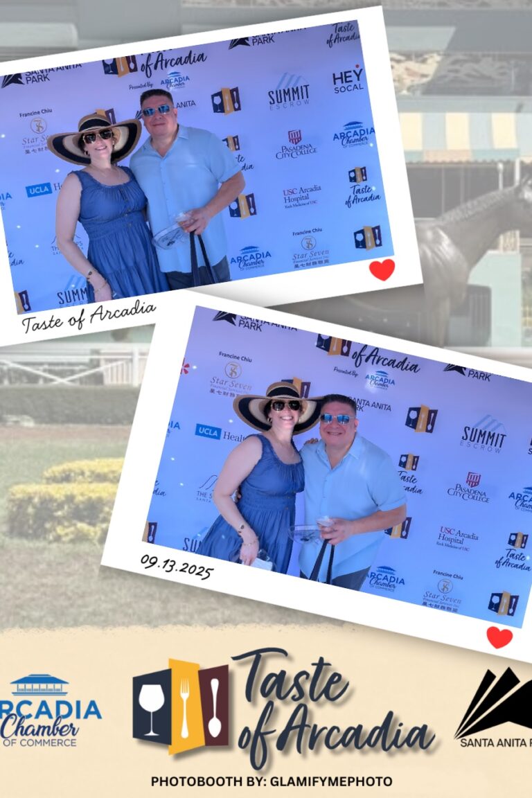 a woman in a blue dress with a man in a white button down in a photo booth setting with a background showing the Taste of Arcadia logo