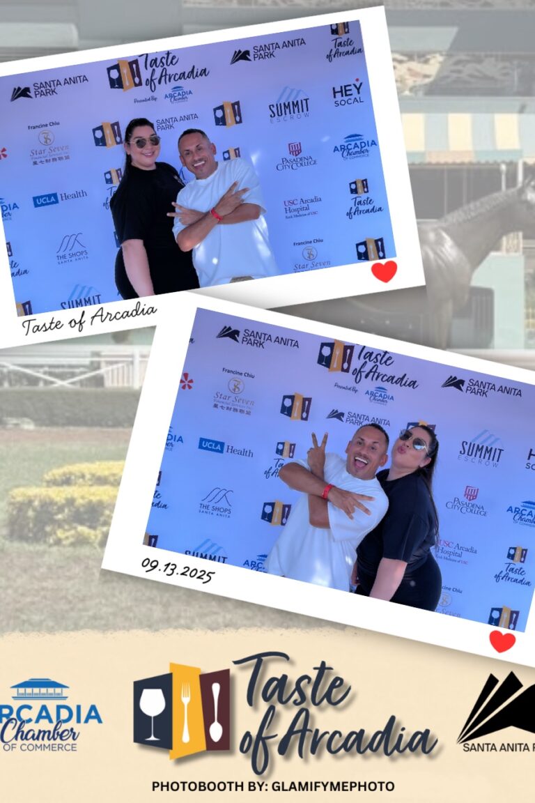 a woman in all black with a man wearing a white t-shirt in a photo booth setting with a background showing the Taste of Arcadia logo