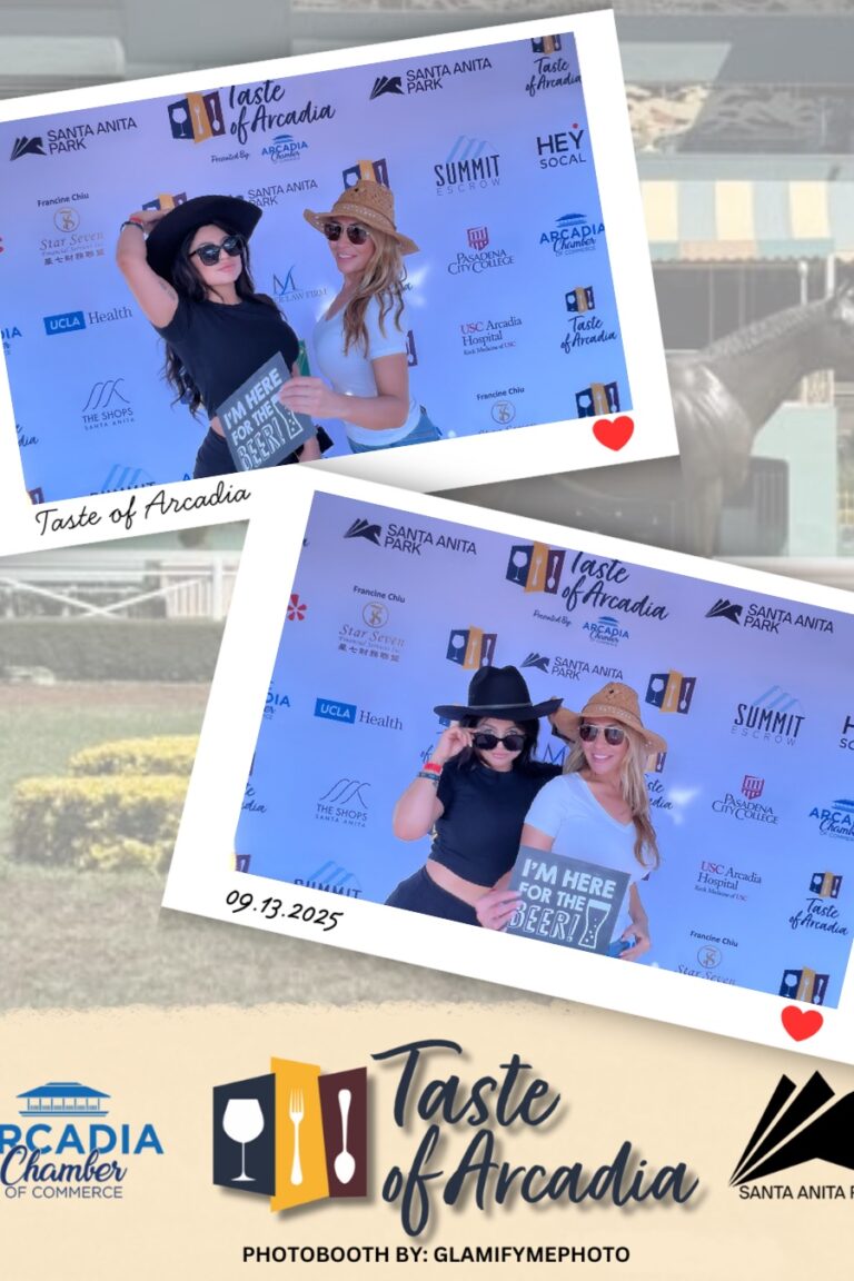 two women wearing cowboy hats in a photo booth setting with a background showing the Taste of Arcadia logo