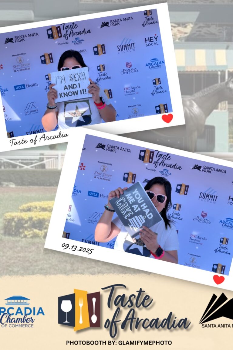 a woman holding funny signs in a photo booth setting with a background showing the Taste of Arcadia logo