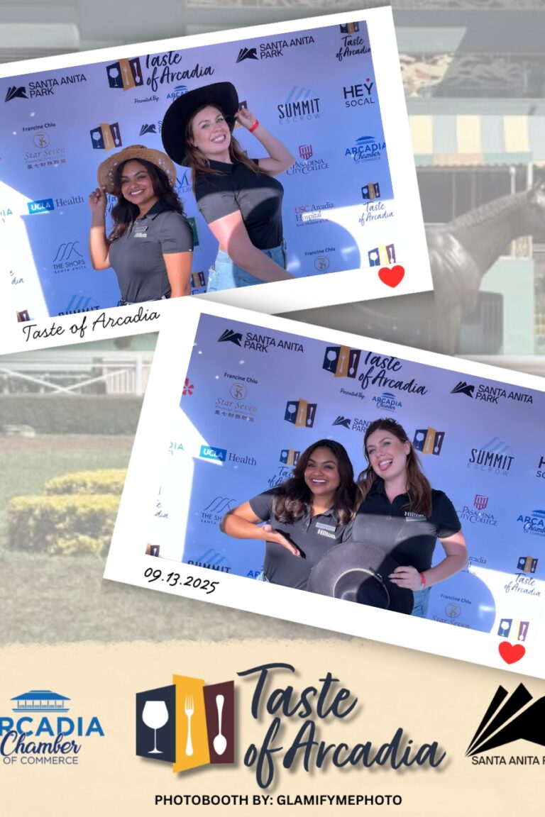 two women in hats in a photo booth on a background with the Taste of Arcadia logo