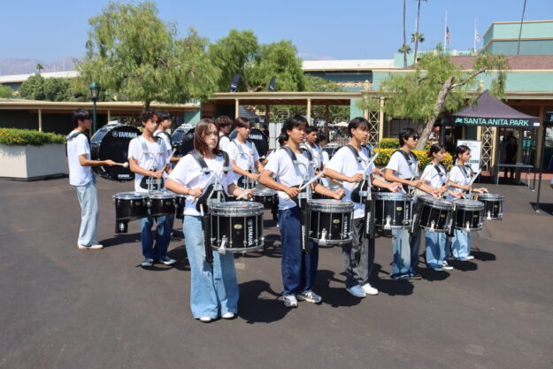 Arcadia High School Marching Drum Line playing in front of Santa Anita Park