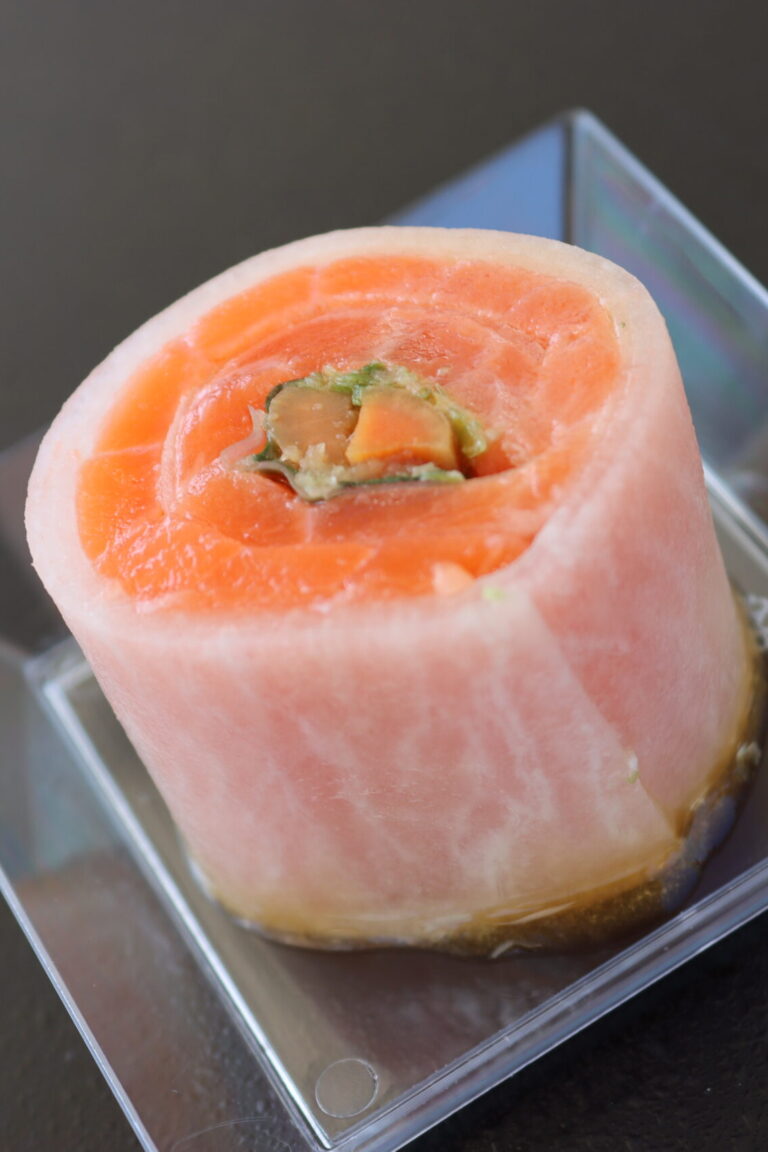 a daikon salmon roll on a plastic plate from Fillet Sushi