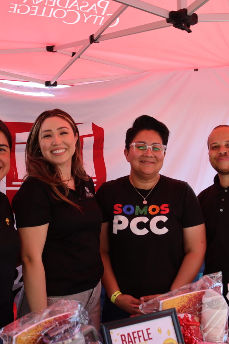 a group of a woman and three men beneath a tent for Pasadena City College