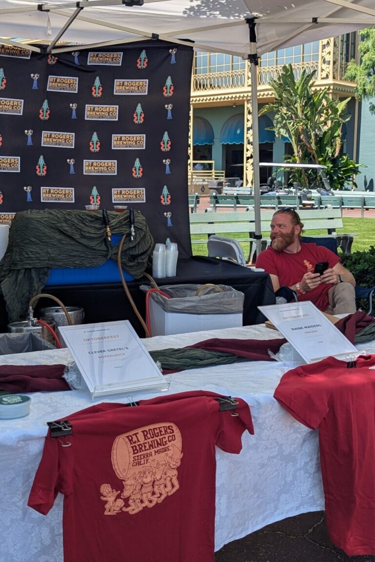 a man behind a booth for RT Rogers at Taste of Arcadia