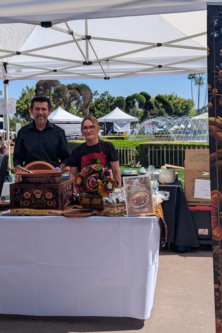 a woman and a man behind a booth for Girasol at Taste of Arcadia