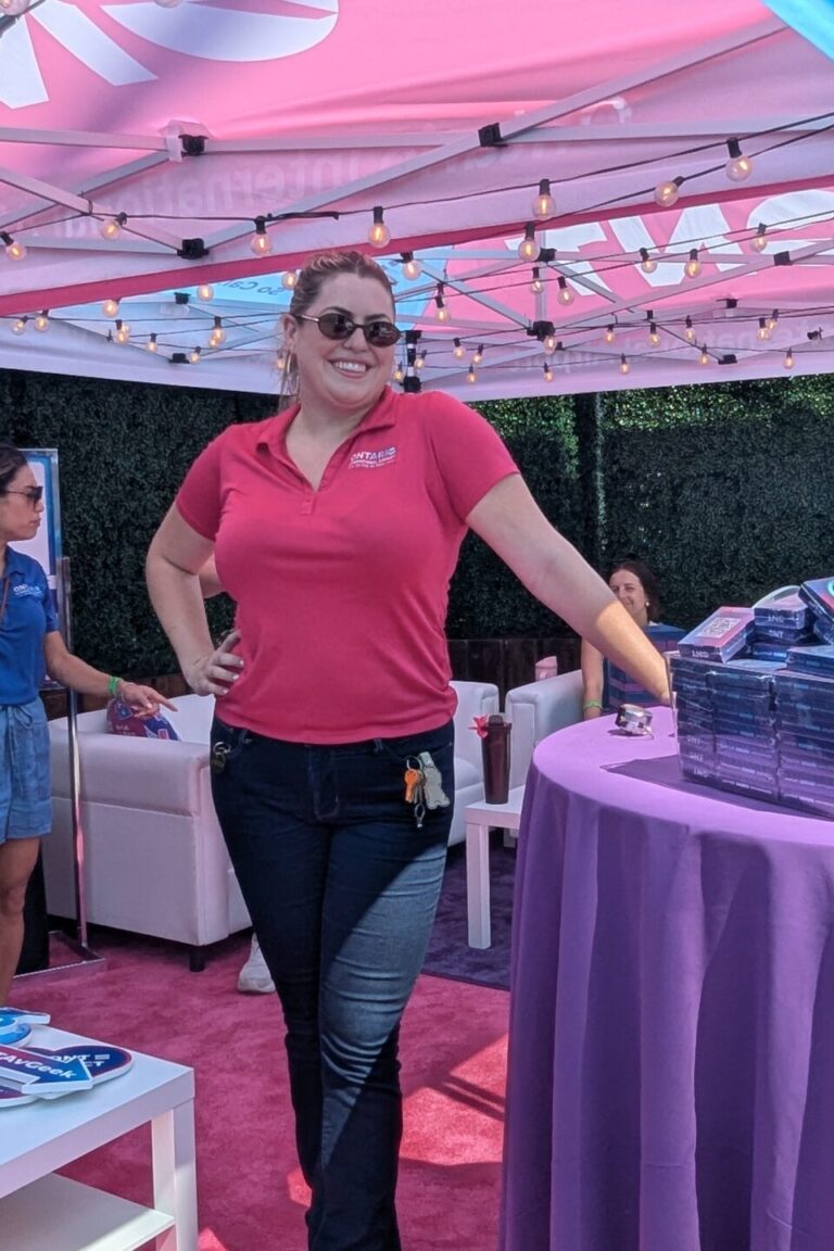 a woman in a pink Ontario Airport shirt in the lounge at Taste of Arcadia