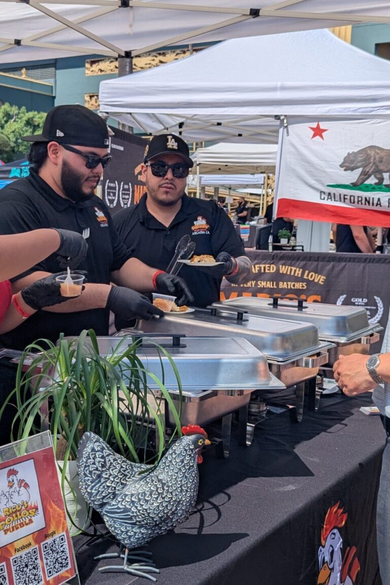 a group of people at the Xolo Tequila booth at Taste of Arcadia