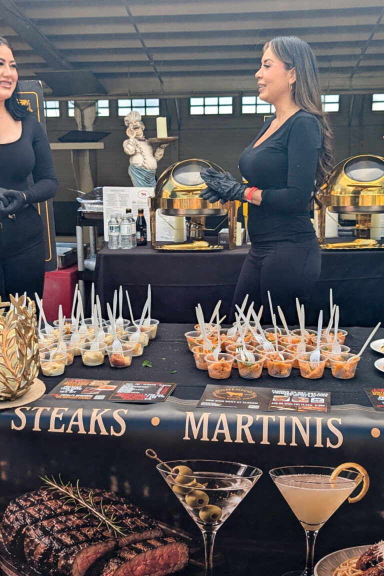 a group of women behind a booth for Domenico's at Taste of Arcadia