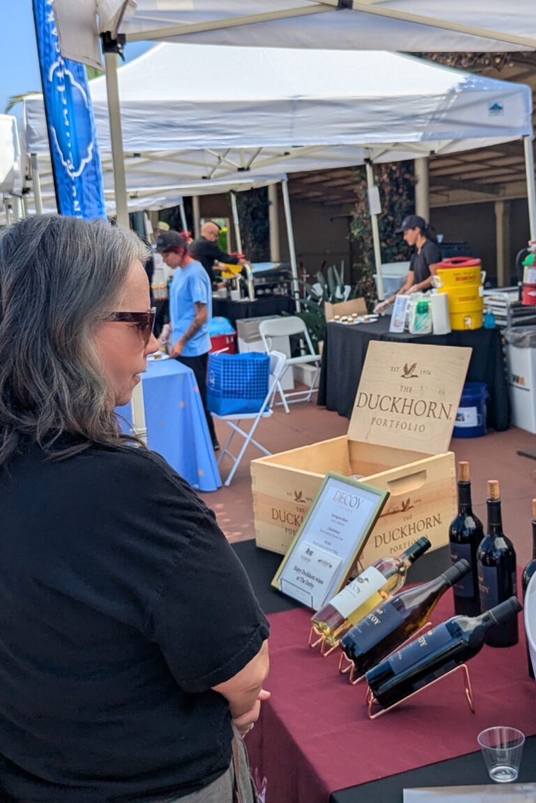 people visiting a booth for Duckhorn wines at Taste of Arcadia