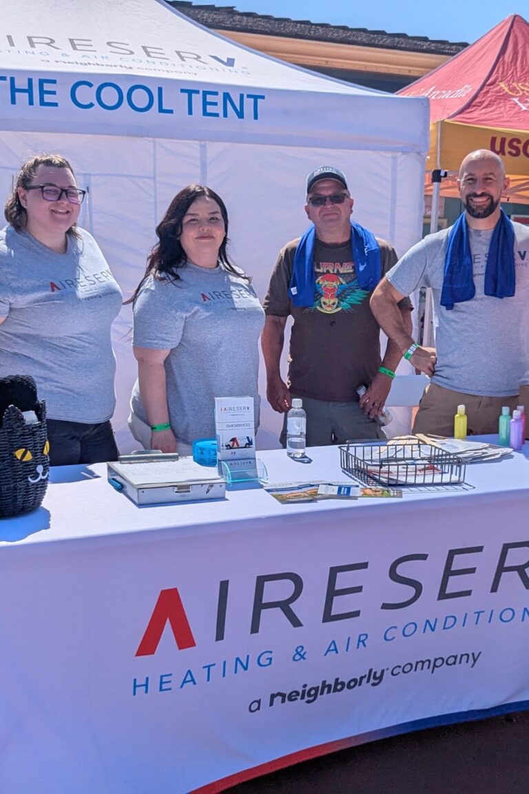 a group pf people at the Aire Serv cooling tent at Taste of Arcadia