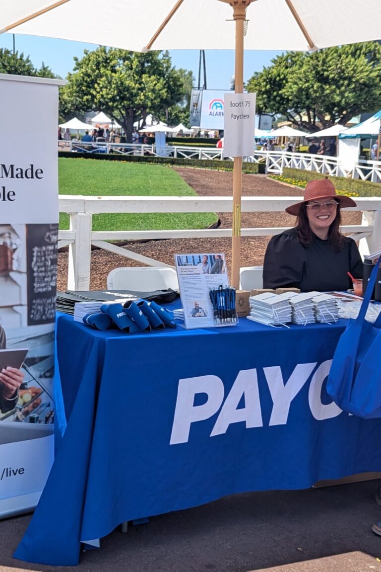 a person visiting a booth for Paychex at Taste of Arcadia