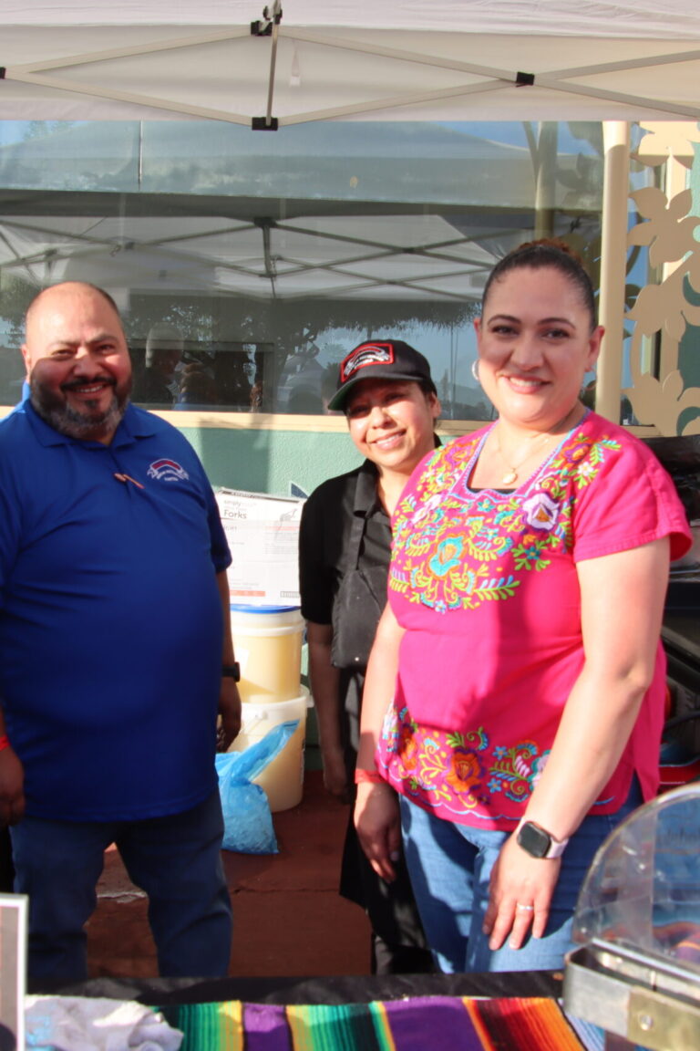 two women and two men behind a booth for Villa Catrina at Taste of Arcadia
