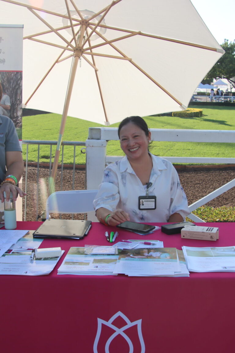two women seated behind a Rose Hills booth at Taste of Arcadia