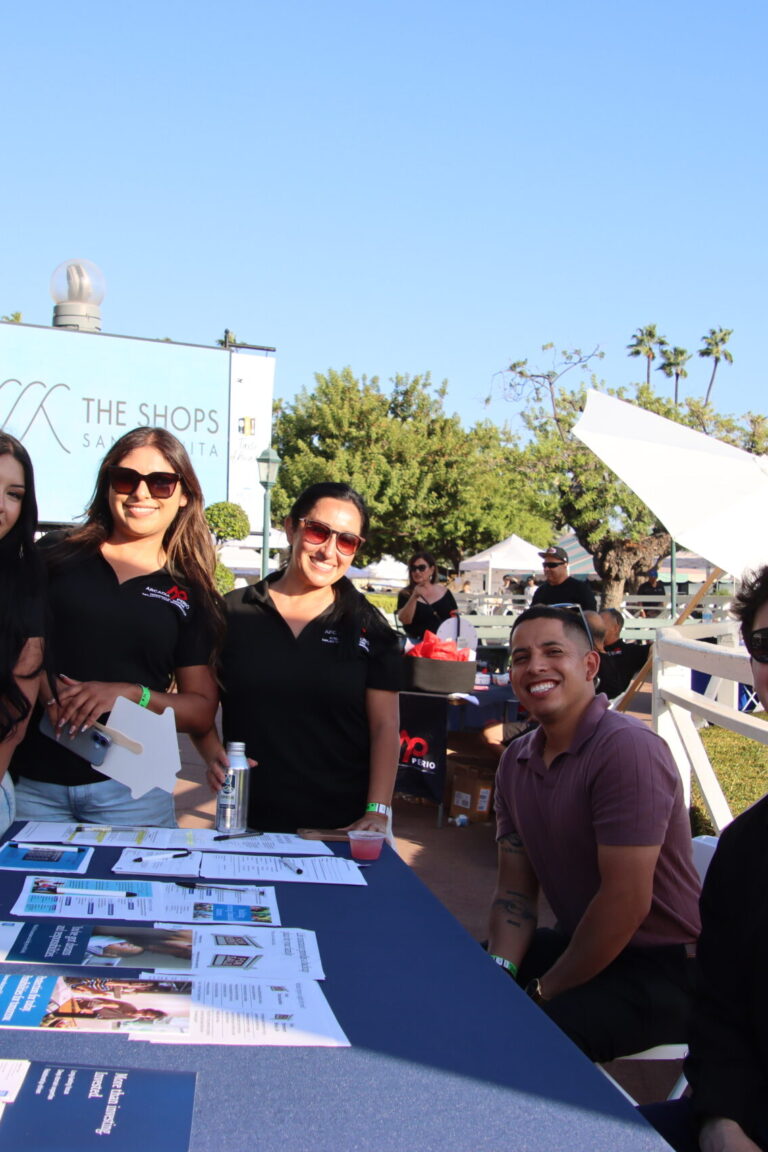 a group of women from Arcadiaperio standing with two men from New York Life at Taste of Arcadia