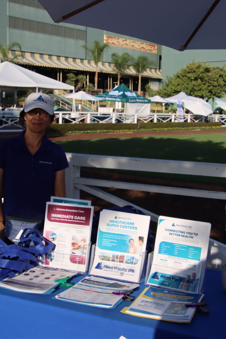 a woman by a booth for Allied Pacific at Taste of Arcadia