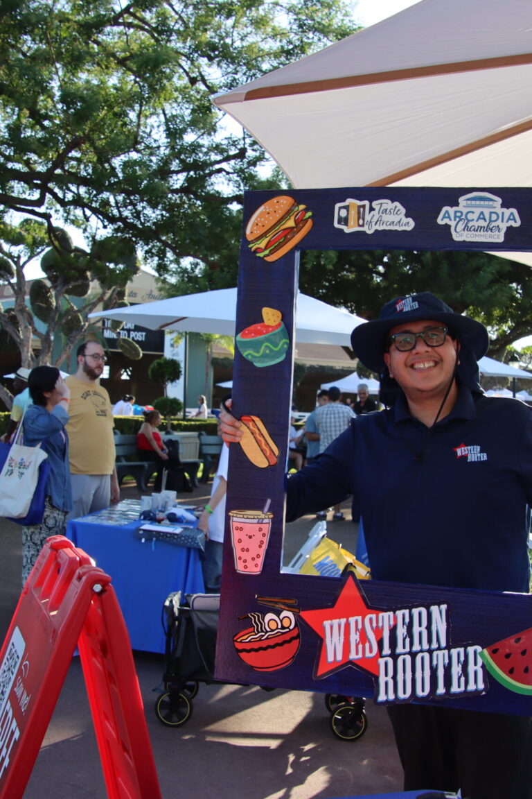 a man holding up a photo frame for Western Rooter at Taste of Arcadia