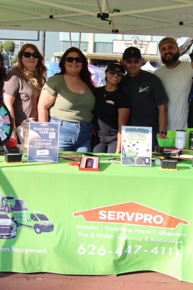 a large group of people in a booth for Servpro at Taste of Arcadia
