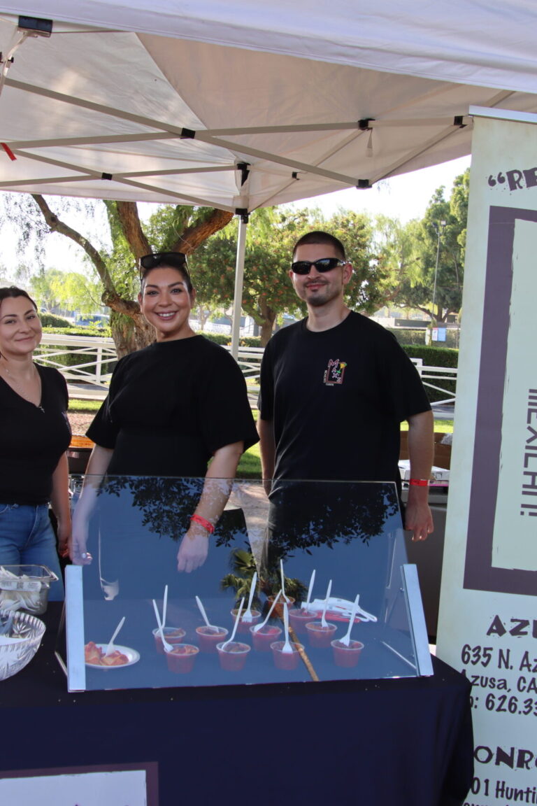 two women and a man behind a booth for Max's at Taste of Arcadia