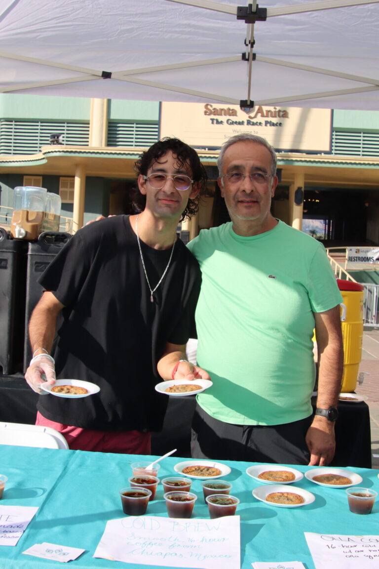 two men holding plates of cookies from Goki Cafe at Taste of Arcadia