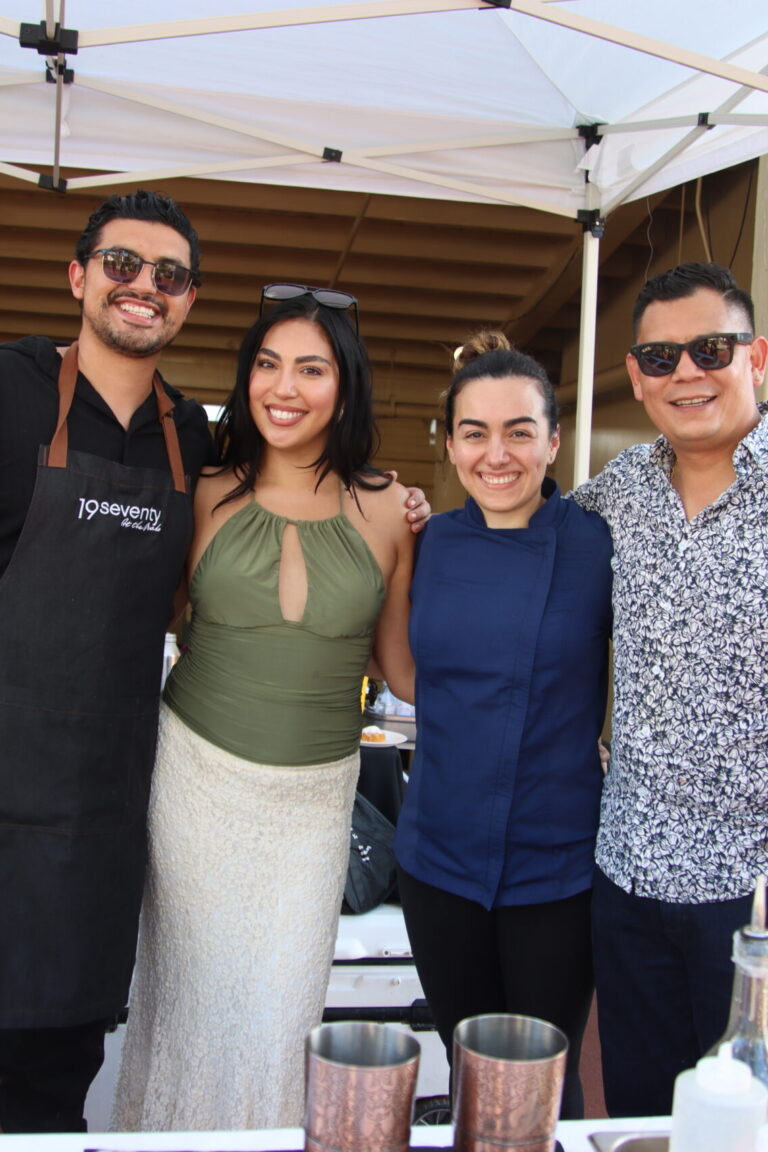 two women in between two men at the 19Seventy Booth at Taste of Arcadia