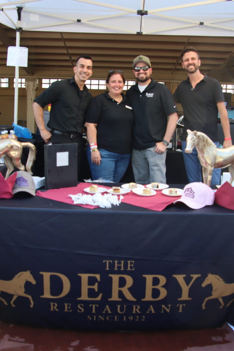 a woman and three men at a booth for the Derby at Taste of Arcadia