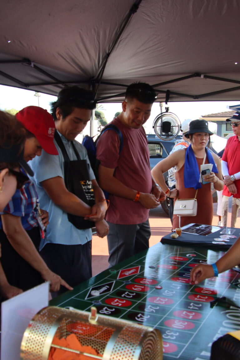 a group of people playing roulette at the Longo Toyota booth at Taste of Arcadia